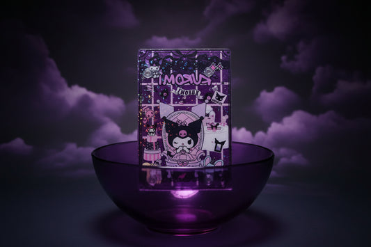NOTEBOOK IN THE MIDDLE OF PURPLE BOWL WITH CLOUDY BLACK AND PURPLE BACKROUND